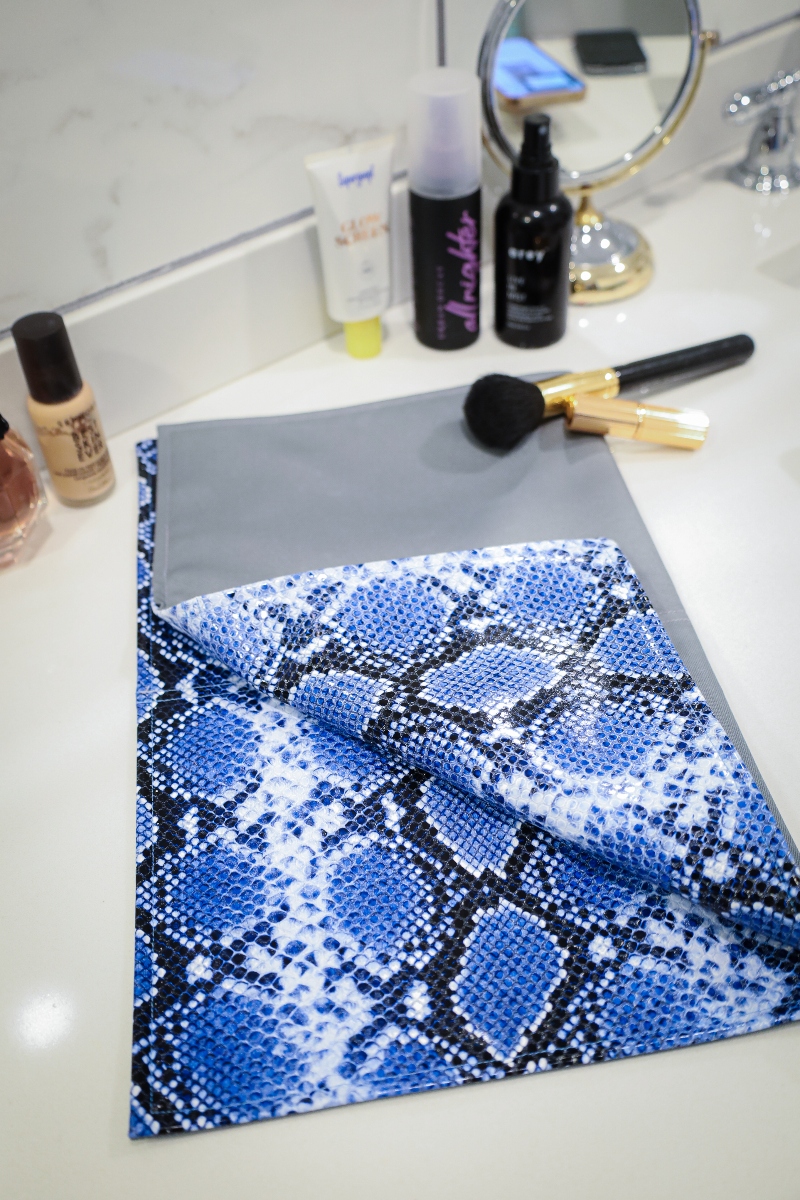 Stylish makeup mat folded up on bathroom counter